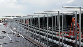 Butler Steel frames An array of mid-construction Butler Steel frames with scattered construction equipment.
