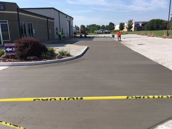 ImpactLife concrete driveway A freshly poured concrete driveway drying in front of the ImpactLife Burlington location. Lowes is visible in the background.
